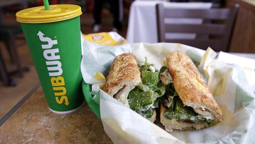 FILE - In this Friday, Feb. 23, 2018 file photo, the Subway logo is seen on a soft drink cup next to a sandwich at a restaurant in Londonderry, N.H.. Ireland