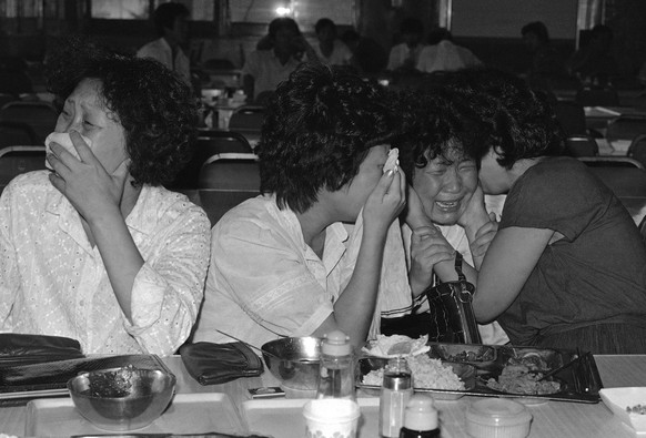 FILE - In this Sept. 2, 1983, file photo, sisters of Lee Chul-Kyu, a passenger on the Ill-fated Korean-Air Lines 747 jetliner, weep, as South Korean government spokesman Lee Jin-Hie announced in Seoul ...