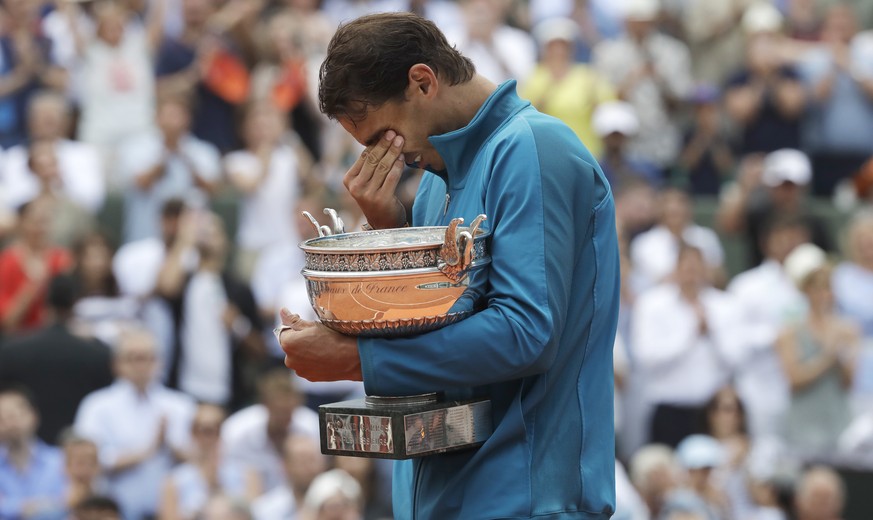 Spain&#039;s Rafael Nadal holds the trophy as he celebrates winning the men&#039;s final match of the French Open tennis tournament against Austria&#039;s Dominic Thiem in three sets 6-4, 6-3, 6-2, at ...