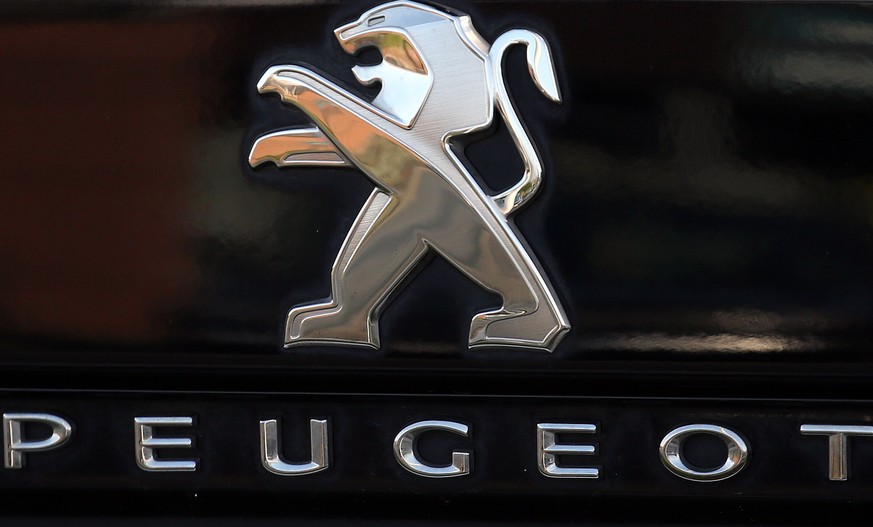 FILE - In this Oct. 31, 2019, file photo, a Peugeot logo pictured on a car in Bayonne, southwestern France. Fiat Chrysler Automobiles and PSA Peugeot announced Wednesday, Dec. 18, 2019, that their boa ...