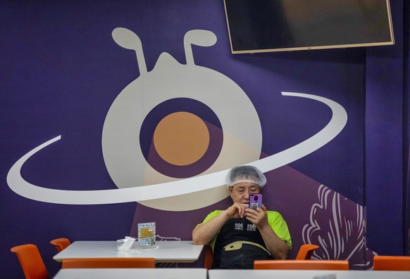 epa08702969 A man rests in the Ant Group headquarters canteen in Hangzhou, China, 27 September 2020 (issued 28 September 2020). Ant Group is the parent company of China&#039;s largest mobile payments  ...