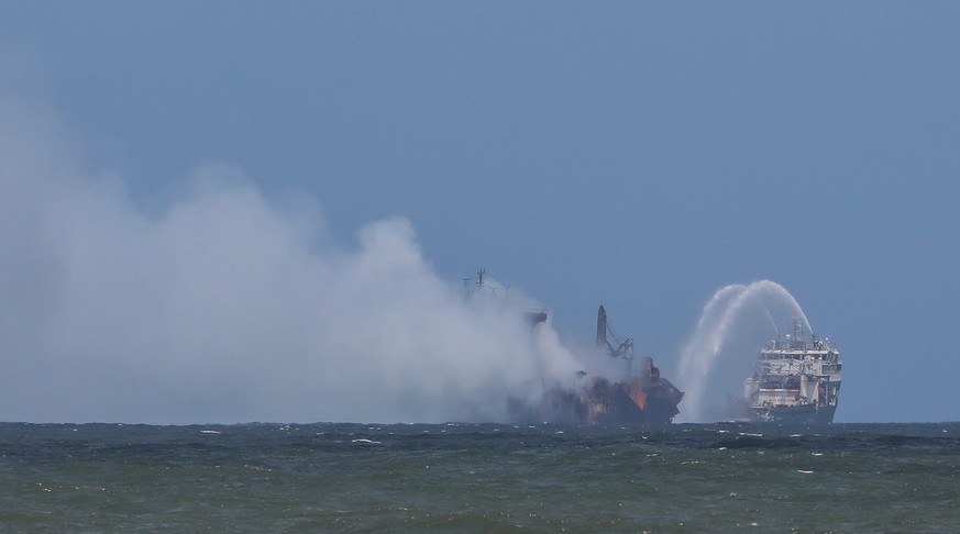 epa09236607 Firefighting boats spray water on the burning container ship MV X-Press Pearl, around 9.5 nautical miles (18km) northwest of Colombo, Sri Lanka, 30 May 2021. A fire broke out on a Singapor ...