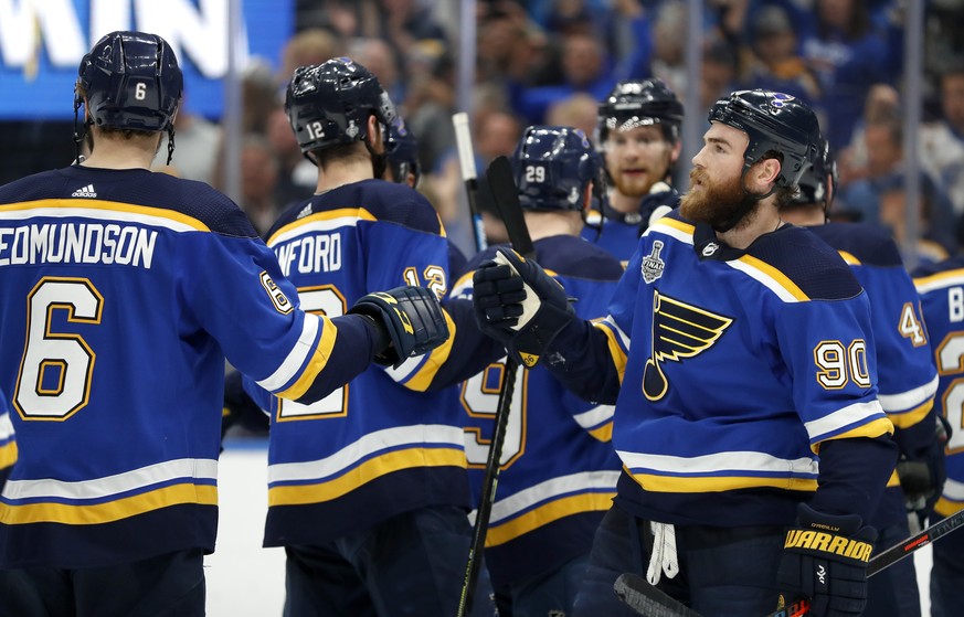St. Louis Blues center Ryan O&#039;Reilly (90) celebrates with Joel Edmundson (6) after the Blues beat the Boston Bruins in Game 4 of the NHL hockey Stanley Cup Final Monday, June 3, 2019, in St. Loui ...