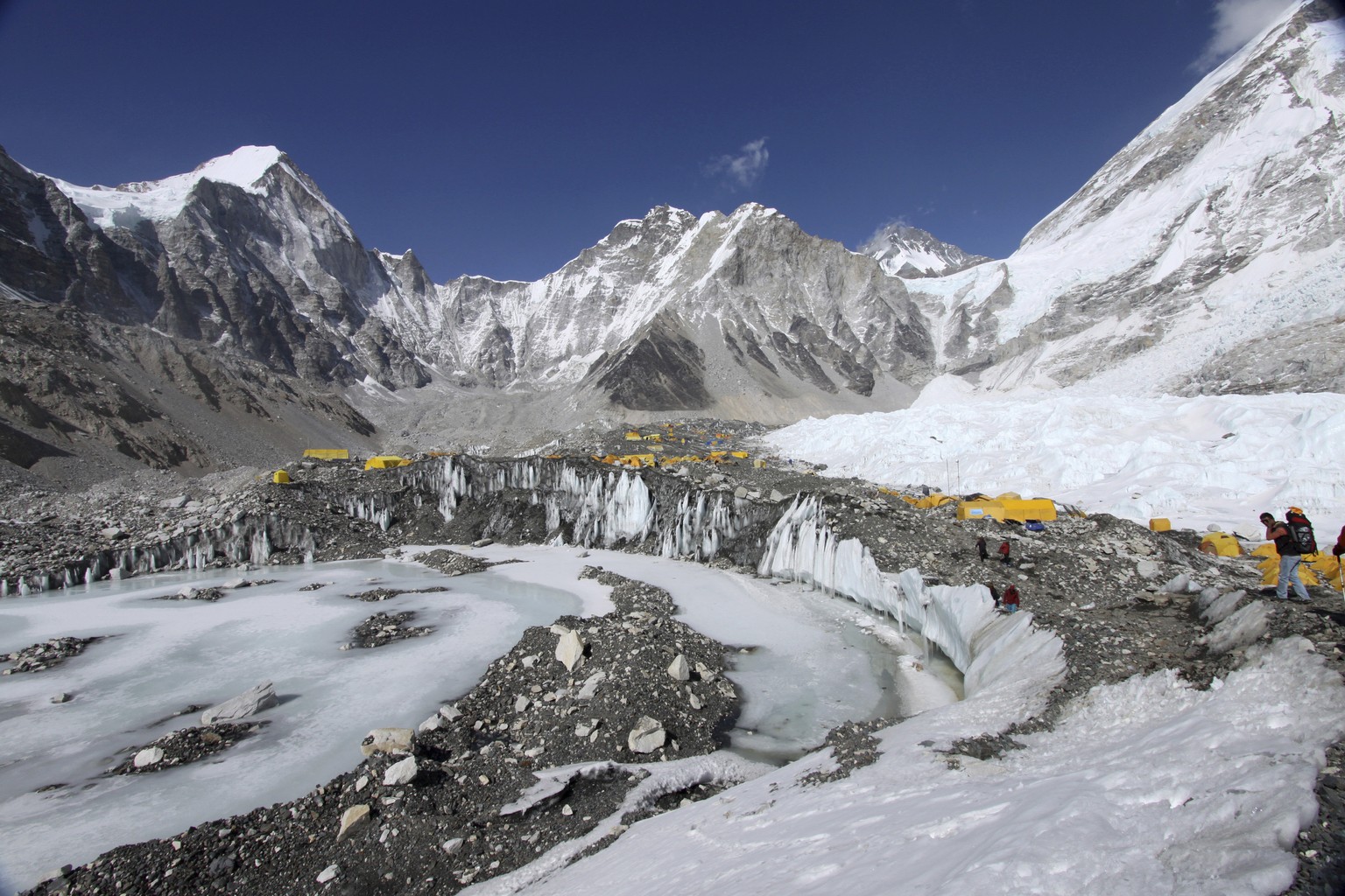 FILE - In this April 11, 2015 file photo, tents are seen set up for climbers on the Khumbu Glacier, with Mount Khumbutse, center, and Khumbu Icefall, right, seen in background, at Everest Base Camp in ...