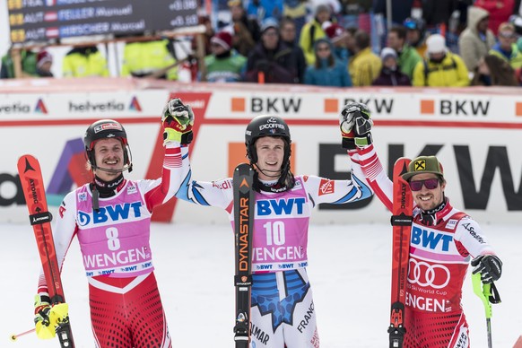 Manuel Feller from Austria as second, Clement Noel from France as the winner and Marcel Hirscher from Austria as third, from left, celebrate in the finish area during the second run of the men&#039;s  ...