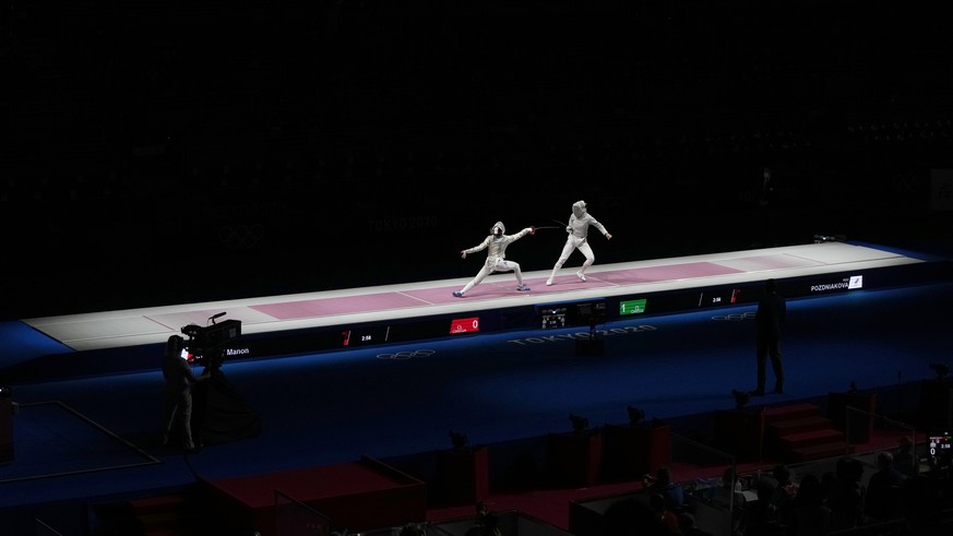 Sofia Pozdniakova of the Russian Olympic Committee, right, and Manon Brunet of France compete in the women&#039;s individual semifinal Sabre competition at the 2020 Summer Olympics, Monday, July 26, 2 ...