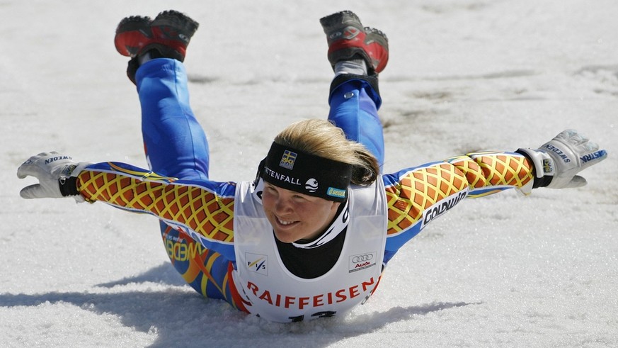 Picture 4 of 4 - Anja Paerson of Sweden runs to do her traditional victory jump and slide in the finish area after winning the women&#039;s World Cup Super-G during the Alpine Ski World Cup finals, in ...