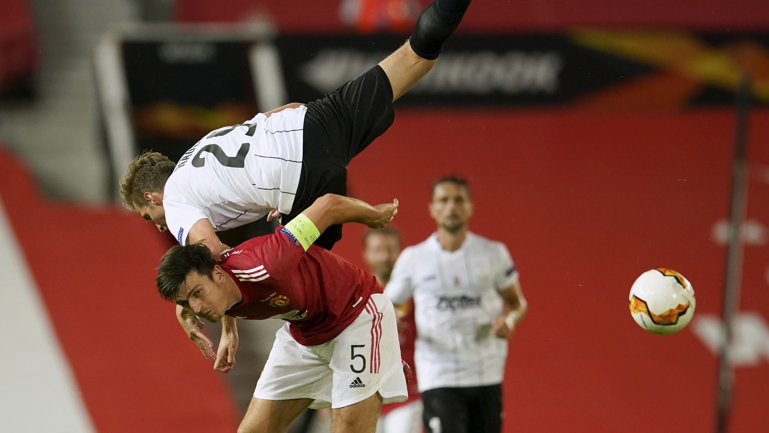 LASK&#039;s Marko Raguz is airborne as he battles for the ball with Manchester United&#039;s Harry Maguire during the Europa League round of 16 second leg soccer match between Manchester United and LA ...