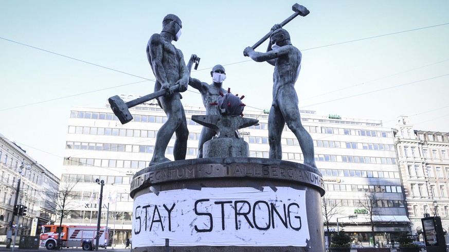epa08334291 A banner at the Three Smiths Statue reads &#039;Stay Strong&#039; in Helsinki, Finland, 31 March 2020. According to the Johns Hopkins University, Finland has registered at least 1,418 COVI ...