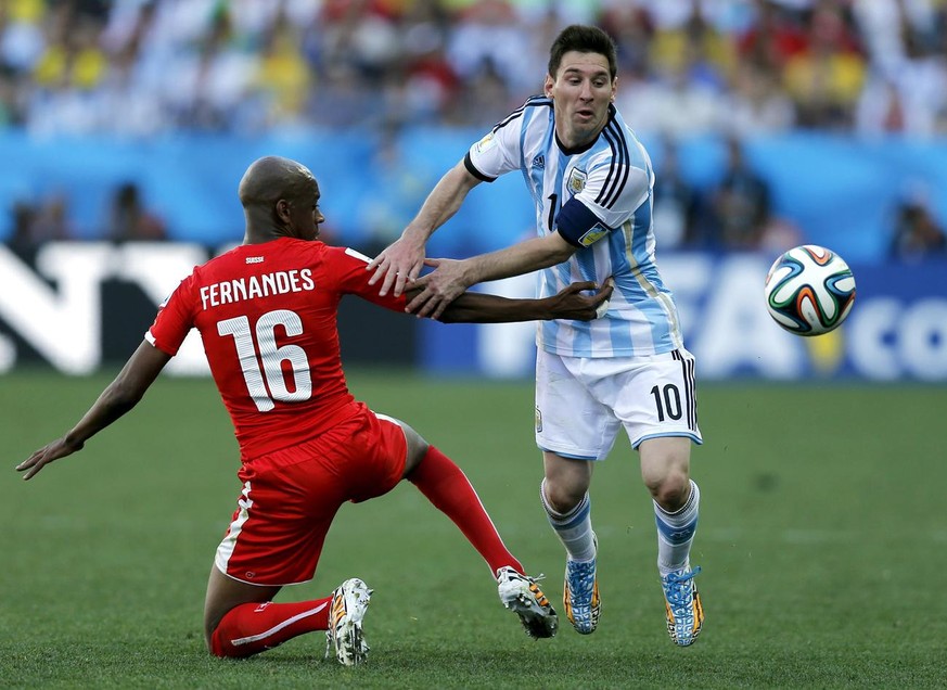 Switzerland&#039;s Gelson Fernandes, left, tries to stop Argentina&#039;s Lionel Messi during the World Cup round of 16 soccer match between Argentina and Switzerland at the Itaquerao Stadium in Sao P ...