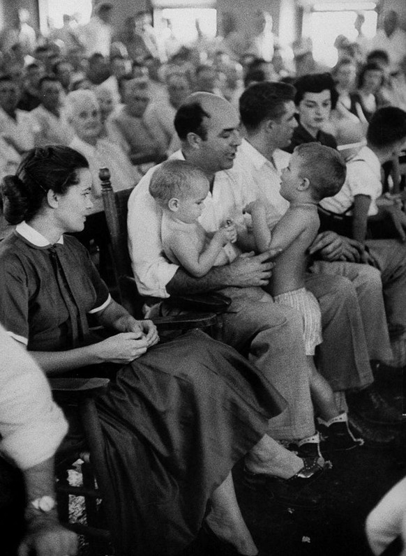 Defendant J W Milam (C) talking with his sons during his trial for the murder of Emmett Till. (Photo by Ed Clark/The LIFE Picture Collection via Getty Images)