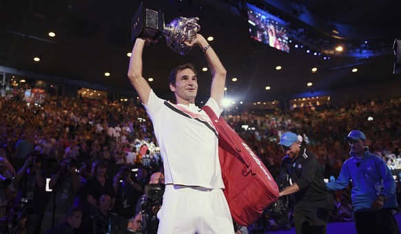 Switzerland&#039;s Roger Federer holds his trophy aloft after defeating Croatia&#039;s Marin Cilic in the men&#039;s singles final at the Australian Open tennis championships in Melbourne, Australia,  ...