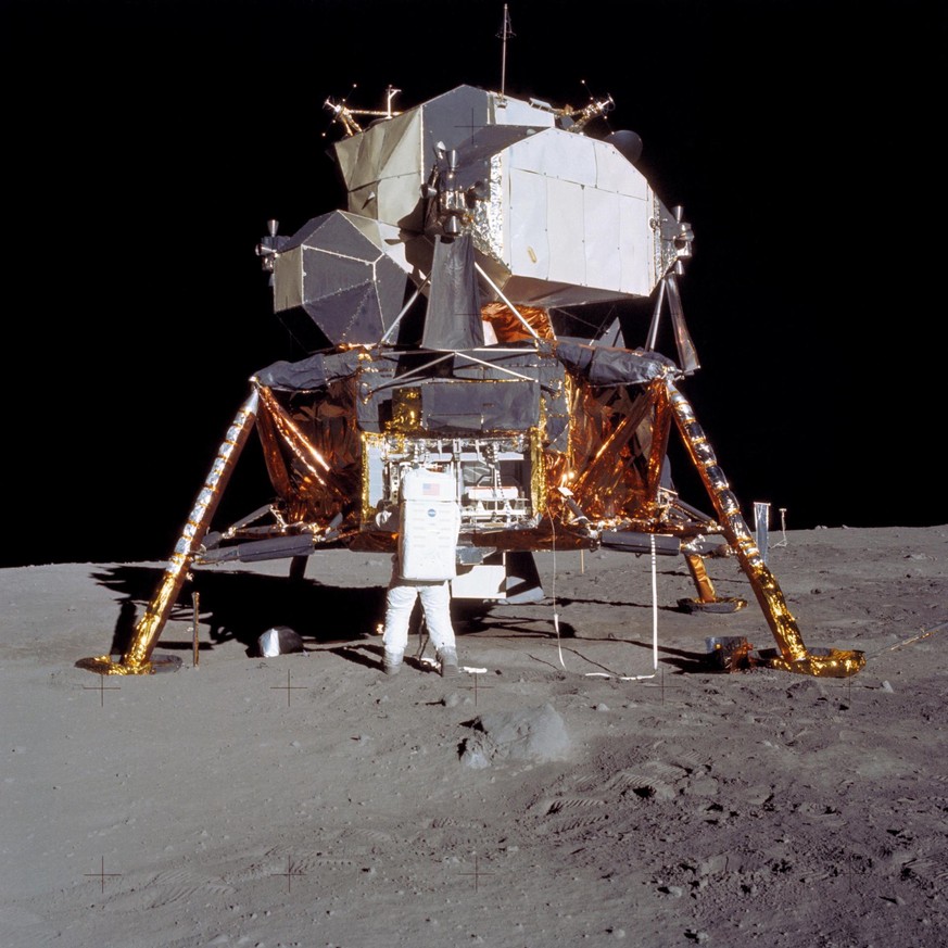 Astronaut Edwin E. Aldrin Jr., lunar module pilot, prepares to deploy the Early Apollo Scientific Experiments Package (EASEP) during the Apollo 11 lunar surface extravehicular activity (EVA). Astronau ...