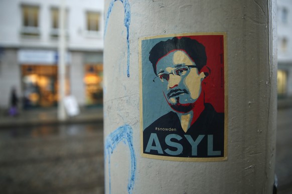 DRESDEN, GERMANY - JANUARY 05: A sticker demanding asylum for whistleblower and former NSA worker Edward Snowden hangs stuck to a lamppost on January 5, 2015 in Dresden, Germany. Many Germans favour g ...