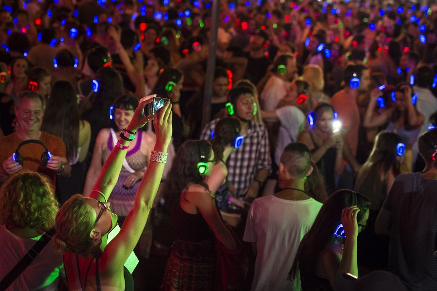 epa07698315 Festival-goers take part in a silent disco during the 53rd Montreux Jazz Festival (MJF) in Montreux, Switzerland, 05 July 2019. The MJF runs from 28 June to 13 July 2019 and features 450 c ...
