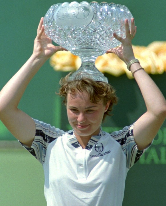Martina Hingis, of Switzerland, holds her trophy after defeating Monica Seles, of Sarasota, Florida, 6-2, 6-1 at the Lipton Championships in Key Biscayne, Florida, Saturday, March 29, 1997. (AP Photo/ ...