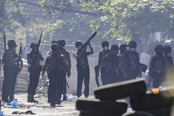 epaselect epa09061017 Police officers seach for hiding demonstrators during a protest in Yangon, Myanmar, 08 March 2021. Major trade unions in Myanmar called on members to go on strike on 08 March to  ...