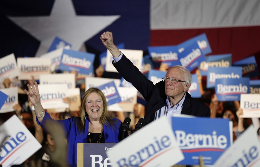Democratic presidential candidate Sen. Bernie Sanders, I-Vt., right, with his wife Jane, raises his hand as he speaks during a campaign event in San Antonio, Saturday, Feb. 22, 2020. (AP Photo/Eric Ga ...