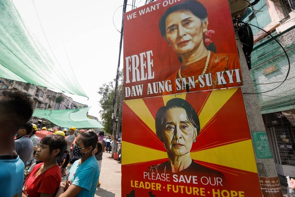 epa09081207 Images of Myanmar ousted leader Aung San Suu Kyi are displayed during a protest against the military coup in Yangon, Myanmar, 18 March 2021. Anti-coup protests continued despite the intens ...