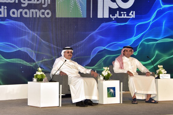 epa07969404 President and CEO of Saudi Aramco Amin Nasser (L) and Aramco chairman Yasir al-Rumayyan attend a press conference to announce an initial public offering of the state oil producer, in Dhahr ...