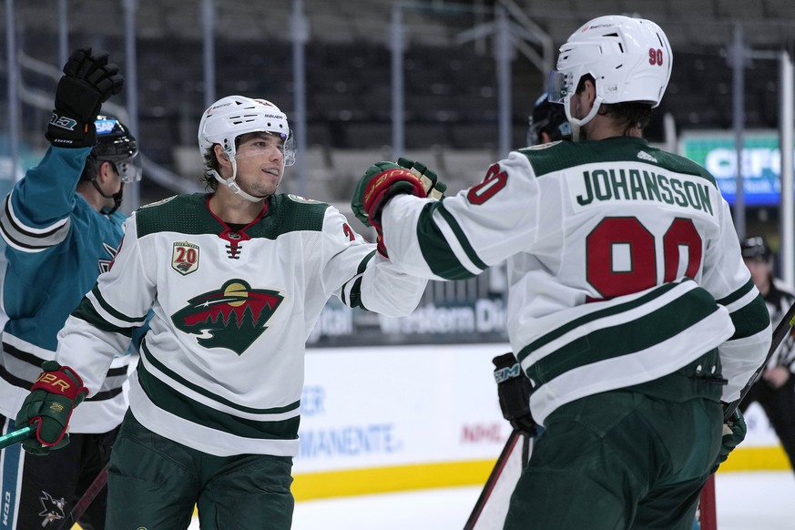 Minnesota Wild left wing Kevin Fiala (22) is congratulated by Marcus Johansson (90) after scoring a goal against the San Jose Sharks during the second period of an NHL hockey game Saturday, April 24,  ...