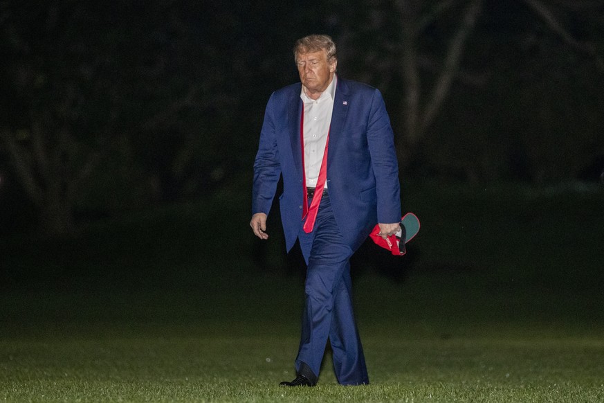 President Donald Trump, returning from a campaign rally in Tulsa, Okla., walks across the South Lawn of the White House in Washington after stepping off the Marine One helicopter, early Sunday, June 2 ...