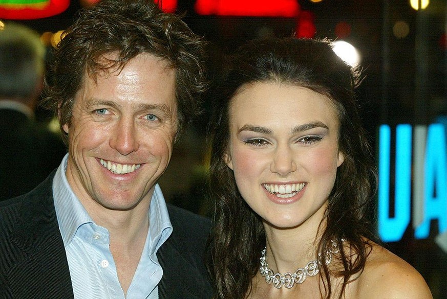 LONDON - NOVEMBER 16: Actors Keira Knightley and Hugh Grant attend the UK charity film premiere of &quot;Love Actually&quot; at The Odeon Leicester Square on November 16, 2003 in London. (Photo by Dav ...