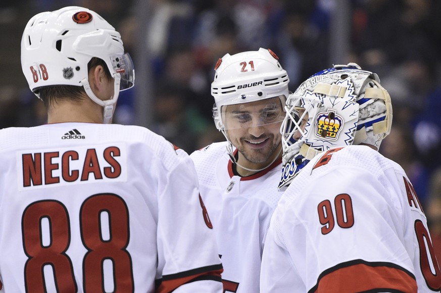 Carolina Hurricanes right wing Nino Niederreiter (21) and center Martin Necas (88) speak to Hurricanes emergency goalie David Ayres as he takes the ice against the Toronto Maple Leafs during second-pe ...