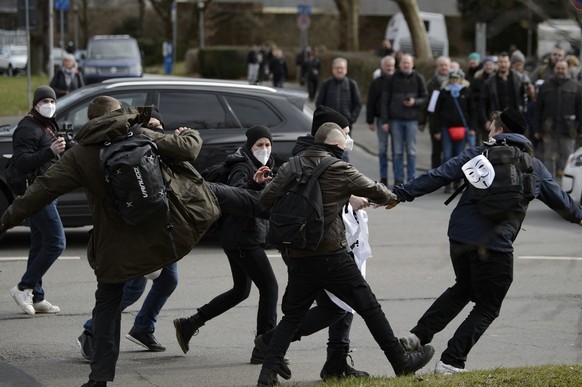 Participants scuffle at a rally under the slogan &quot;Free citizens Kassel - basic rights and democracy&quot; in Kassel, Germany, Saturday, March 20, 2021. According to police, several thousand peopl ...
