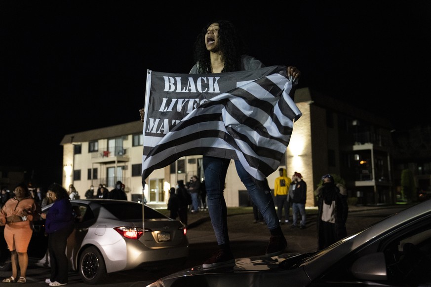 A demonstrator yells towards authorities during a protest over the fatal shooting of Daunte Wright by a police officer during a traffic stop, near the Brooklyn Center Police Department, Saturday, Apri ...