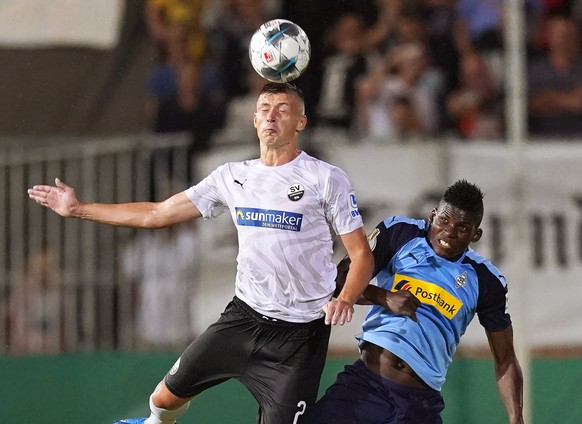 epa07765003 Sandhausen&#039;s Aleksandr Zhirov (L) in action against Moenchengladbach&#039;s Breel Embolo (R) during the German DFB Cup first round soccer match between SV Sandhausen and Borussia Moen ...