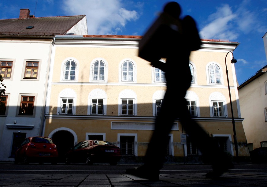 A person passes the house in which Adolf Hitler was born in Braunau am Inn, Austria, September 24, 2012. REUTERS/Dominic Ebenbichler/File Photo
