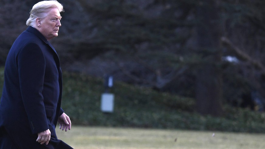 President Donald Trump walks on the South Lawn in a strong brezze, returning to the White House after a day trip to the North Carolina Opportunity Now Summit, Friday, February 7, 2020, in Washington,  ...