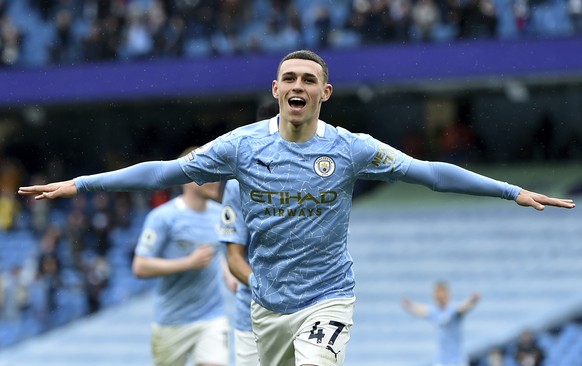 Manchester City&#039;s Phil Foden celebrates scoring his side&#039;s third goal during the English Premier League soccer match between Manchester City and Everton at the Etihad stadium in Manchester,  ...