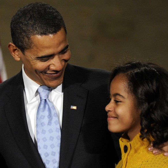 FILE - This Jan. 17, 2009, file photo shows President-elect Barack Obama as he looks at his daughter Malia during an event at the 30th Street Station in Philadelphia before embarking on his Inaugural  ...