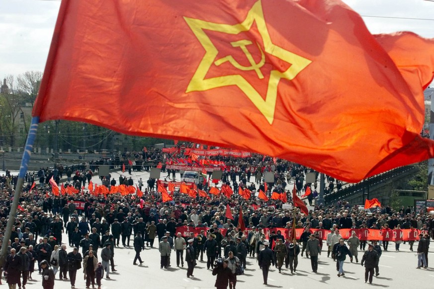 Some of about 7,000 Communist supporters with red flags and banners march along the bridge near the Kremlin in Moscow, Monday, May 1, 2000. Representatives of trade unions and Communists rallied to ma ...