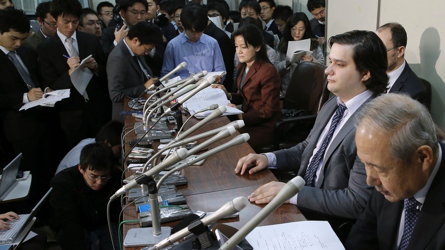 Mt. Gox CEO Mark Karpeles, sitting at second right, attends a press conference at the Justice Ministry in Tokyo Friday night, Feb. 28, 2014. The Mt. Gox bitcoin exchange in Tokyo filed for bankruptcy  ...