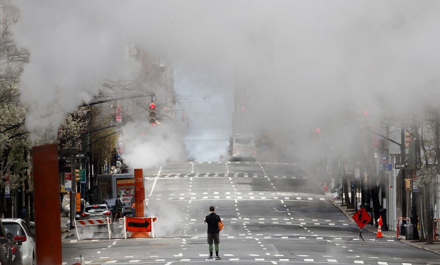 epa08343434 A person crosses a nearly empty Madison Avenue in New York, New York, USA, on 04 April 2020. New York City is still considered the epicenter of the coronavirus outbreak in the United State ...