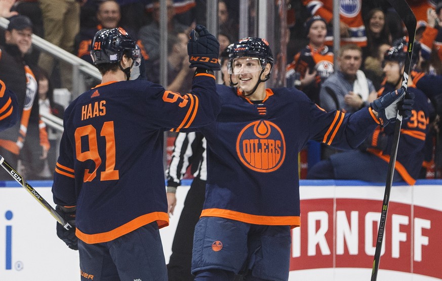 Edmonton Oilers&#039; Gaetan Haas (91) celebrates his goal with Matt Benning (83) during the second period of an NHL hockey game against the New Jersey Devils on Friday, Nov. 8, 2019, in Edmonton, Alb ...