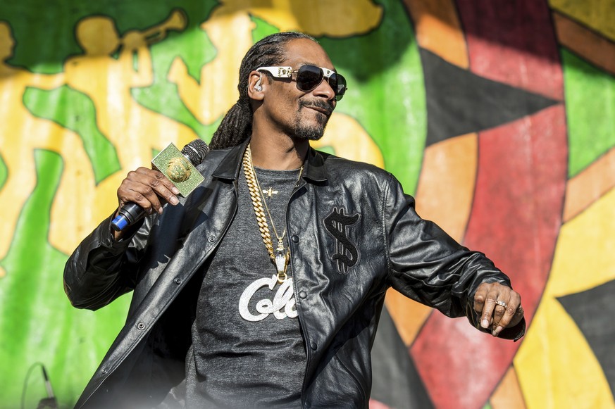 FILE - In this May 6, 2017, file photo, Snoop Dogg performs at the New Orleans Jazz and Heritage Festival in New Orleans. Snoop Dogg says he wants to create a music festival in his father&#039;s homet ...
