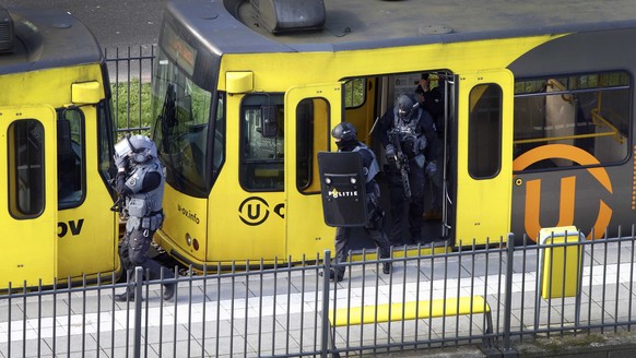 epa07446633 Special Police Forces inspect a tram, after the attack on a tram at the 24 Oktoberplace in Utrecht, The Netherlands, 18 March 2019. According to the the Dutch Police, several people have b ...
