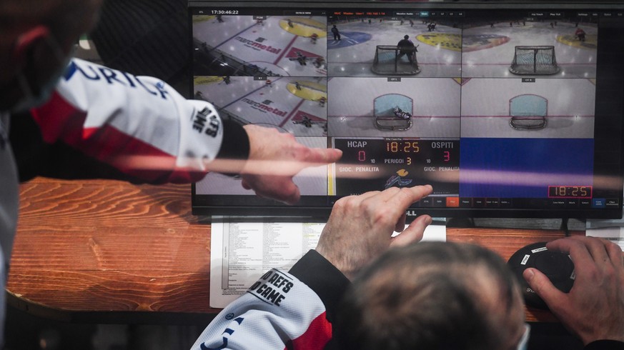 The referees consult the video during the match of National League A (NLA) Swiss Championship 2020/21 between HC Ambri Piotta and SCL Tigers at the ice stadium Valascia in Ambri, Switzerland, Sunday,  ...