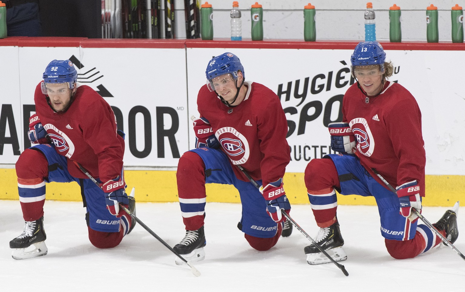 Montreal Canadiens players Jonathan Drouin (92), Artturi Lehkonen (62) and Max Domi (13) look on during NHL hockey training camp in Brossard, Quebec, Friday, Sept. 13, 2019. (Graham Hughes/The Canadia ...