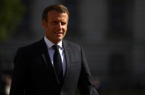 epa08494298 French President Emmanuel Macron reacts after watching The Red Arrows and La Patrouille de France perform a flypast, at Horse Guards Parade in London, Britain, 18 June 2020. French Preside ...