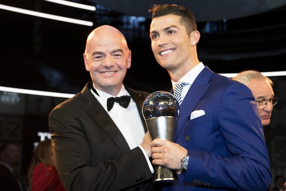 epa05708241 Real Madrid&#039;s Portuguese striker Cristiano Ronaldo (R) holds his trophy after winning the FIFA Men&#039;s Player of the Year 2016 award next to FIFA President Gianni Infantino (L) dur ...