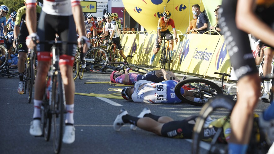 Cyclists are injured in a crash on the final stretch of the opening stage of the Tour de Pologne race in Katowice, Poland, on Wednesday, Aug. 5, 2020. The crash began with a high-speed collision betwe ...