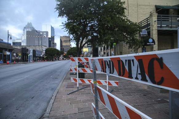 Road block barriers sit on the sidewalk on 6th Street after an early morning shooting on Saturday, June 12, 2021 in downtown Austin, Texas. Authorities say someone opened fire on the busy entertainmen ...