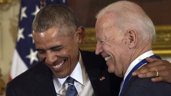 President Barack Obama laughs with Vice President Joe Biden during a ceremony in the State Dining Room of the White House in Washington, Thursday, Jan. 12, 2017. Obama presented Biden with the Preside ...
