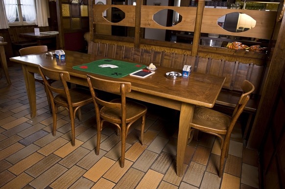 Cards, table carpet, sponge, slate and pen used in the traditional Swiss card game &quot;Jassen&quot; lie on a table at the restaurant Ochsen in Luetzelflueh in the canton of Berne, Switzerland, pictu ...