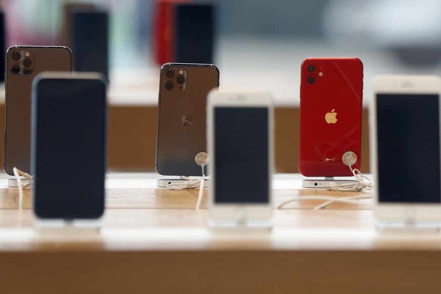 Rows of iPhones are displayed Saturday, March 14, 2020, inside a closed Apple store in downtown Brooklyn in New York. Apple CEO Tim Cook announced the tech giant would close all Apple retail stores ou ...